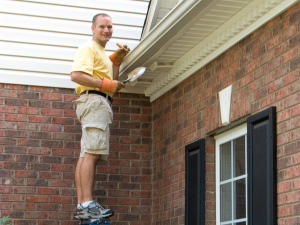 Homeowner following a Brookhaven roofer’s checklist for gutter maintenance
