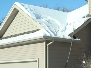 A snowy rooftop in Eatonton, GA, inspected by a professional roofer.