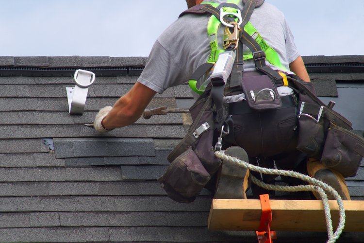Home with storm-damaged roof in Atlanta undergoing repair by professional roofing team.