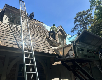 Roof repair in Eatonton fixing storm damaged shingles.